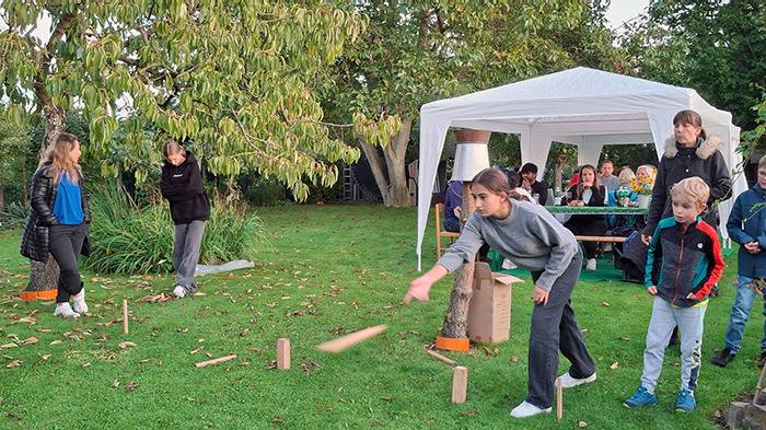 wir beim Kubb spielen und im Hintergrund: wir unter den Pavillons