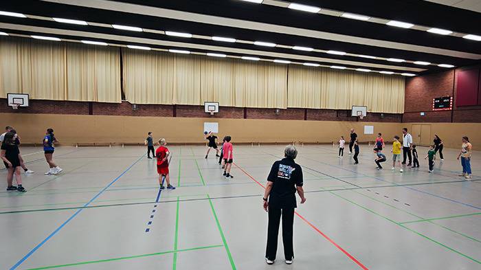 Halle mit Personen beim Völkerball spielen